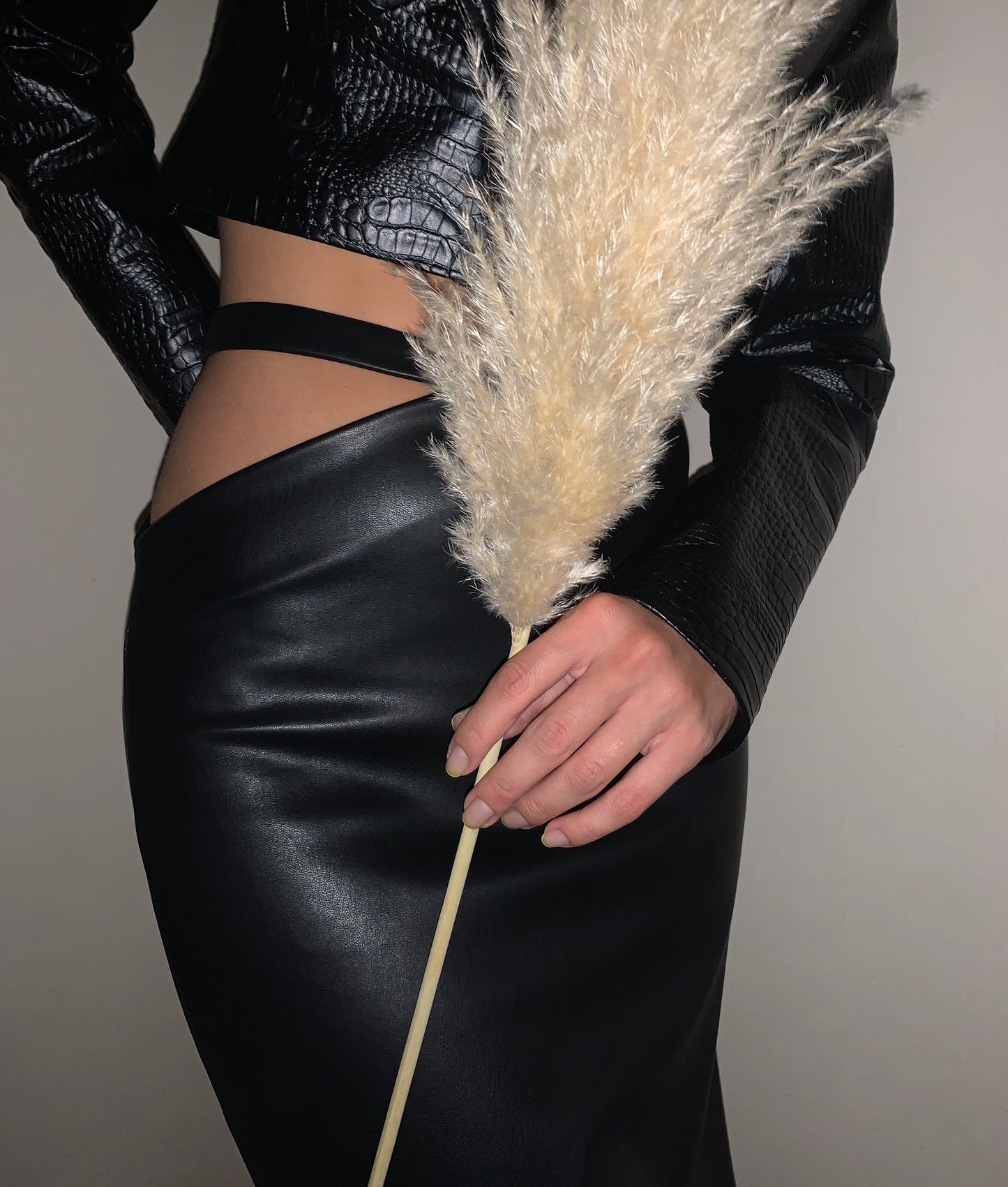 Asymmetrical faux leather midi skirt with waist band.