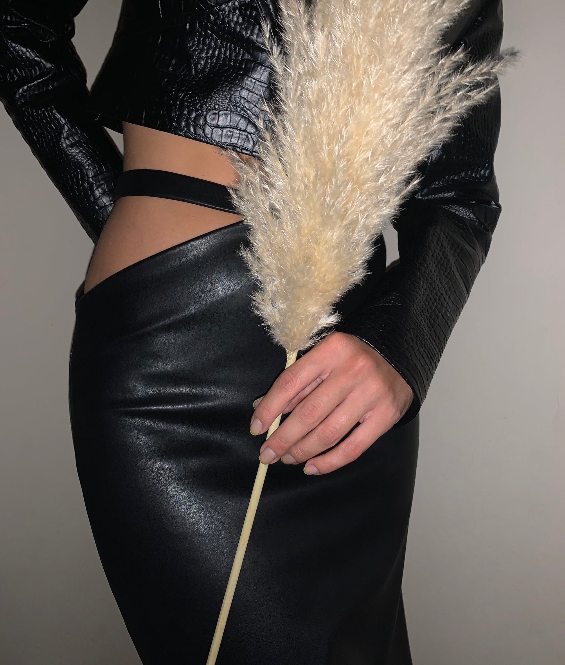 Asymmetrical faux leather midi skirt with waist band.